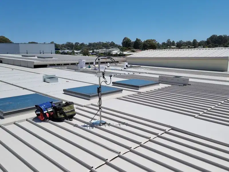 An antenna mast installed on a commercial building rooftop
